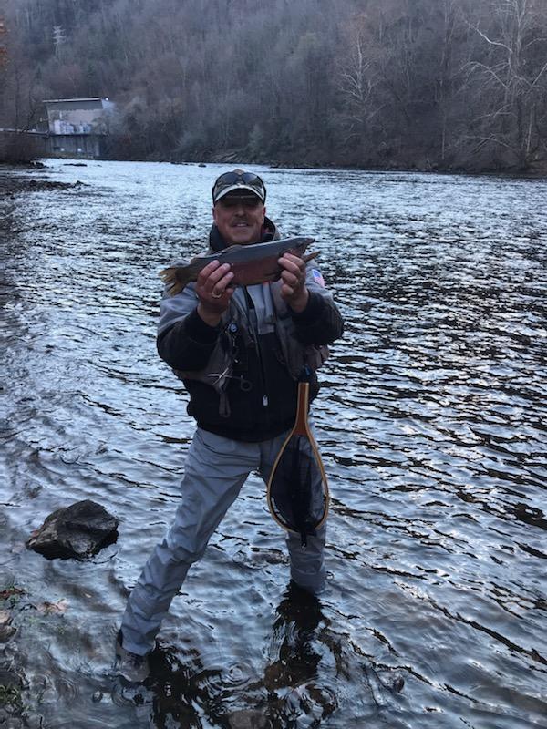 Bobby riverside holding a red belly salmon