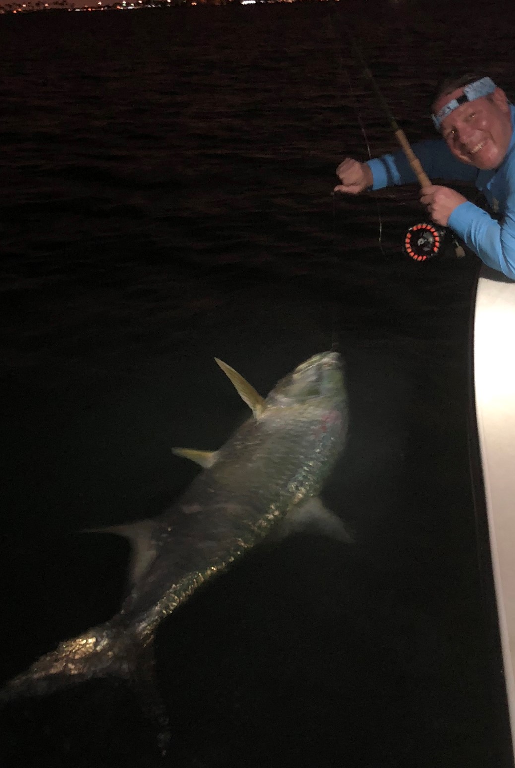 Josh night fishing from a flats boat