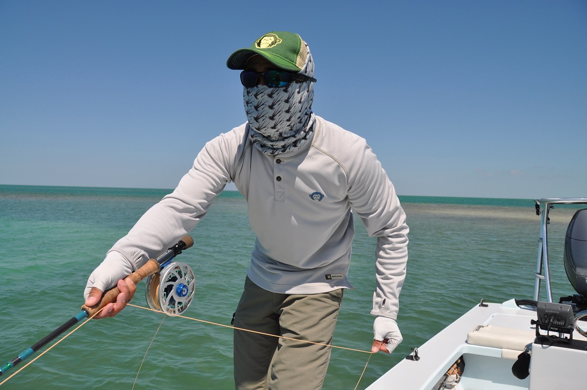 Fly angler on a flats boat setting a hook using a Strip Set