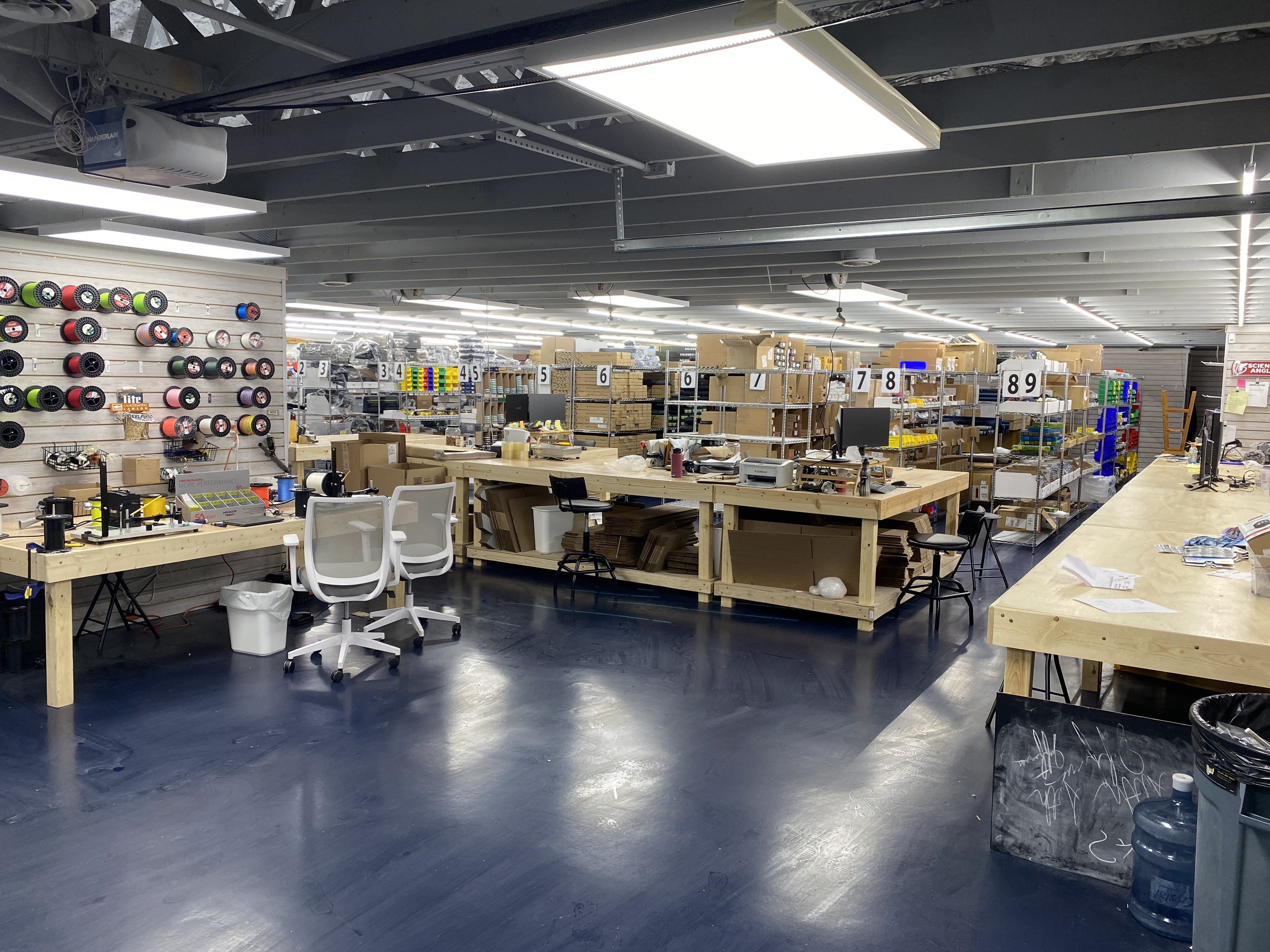 Reel loading table and second shipping desk with the inventory racks in the back