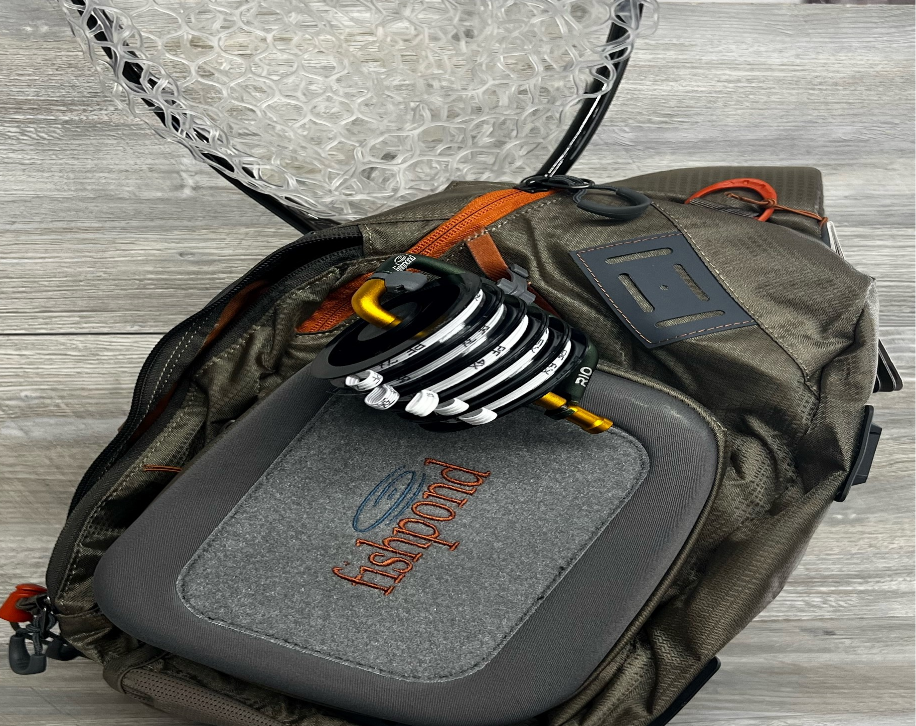 Fully loaded Fishpond Summit Sling 2.0 with tippet, waterbottle and net