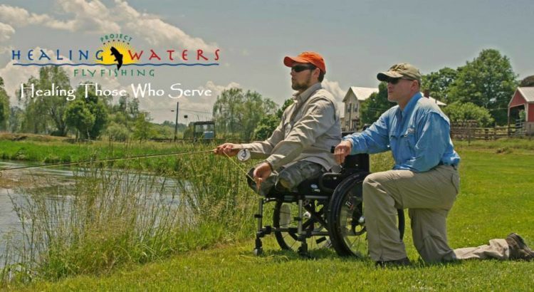 Veteren in wheelchair fishing with Healing Waters memeber