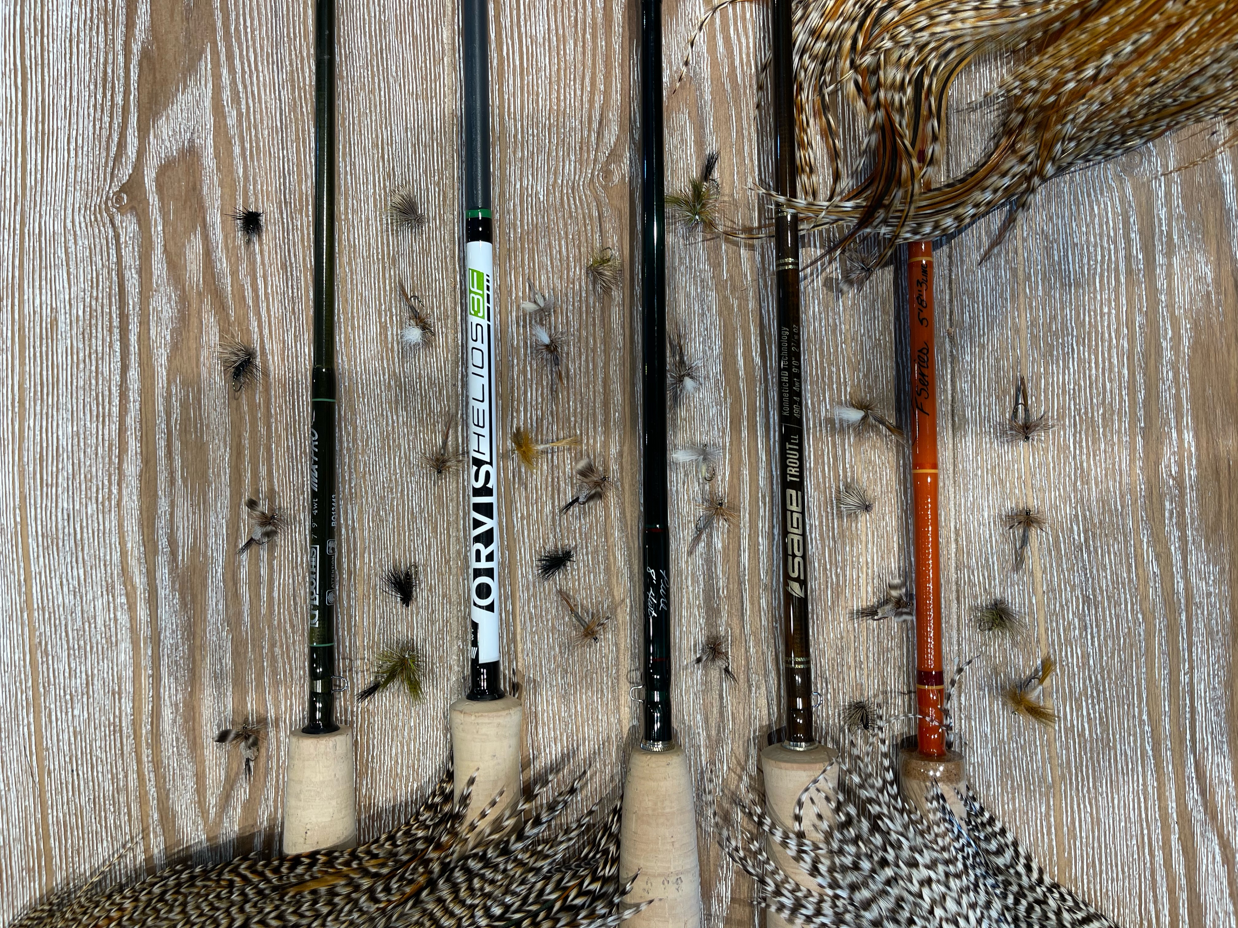 5 top choices of dry fly rods surounded by feathers and flies