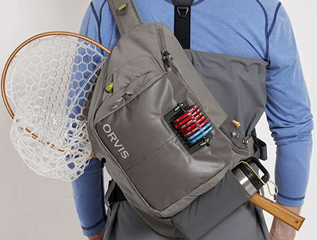 Angler wearing an Orvis Guide Sling loaded with Tippet, Flies, Waterbottle and Net