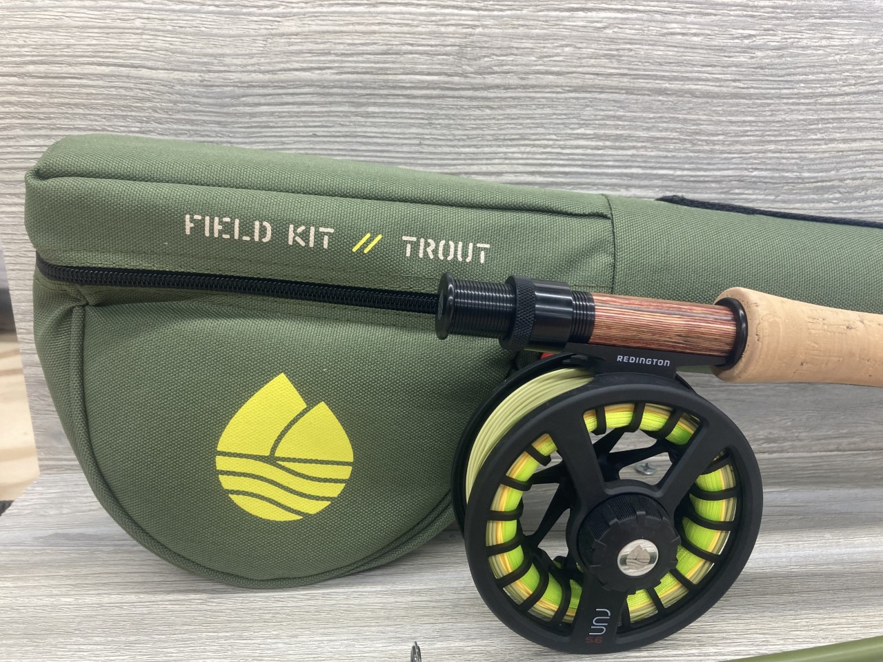 Redington Trout Field Kit Rod and Reel set in front of the protective case