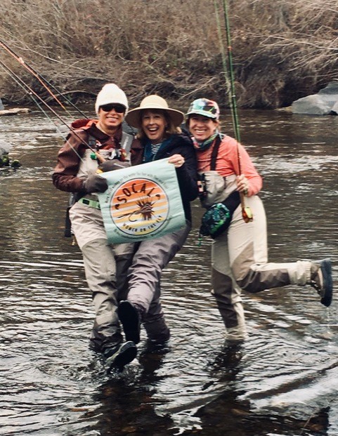 Jen and two other SoCal members on the river with their banner