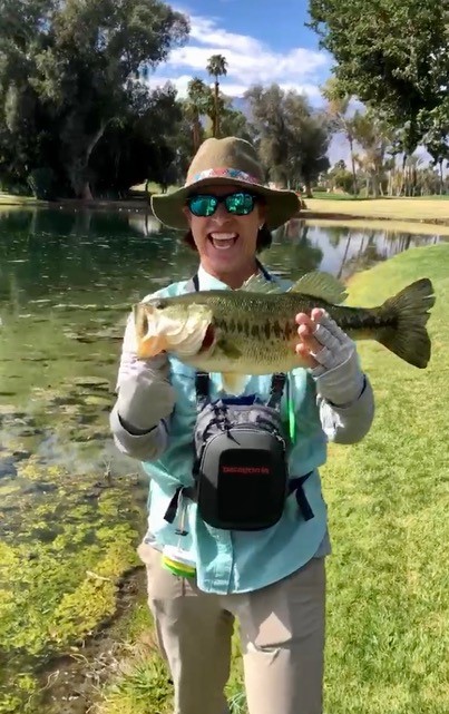 Largemouth being held by Jen pond side
